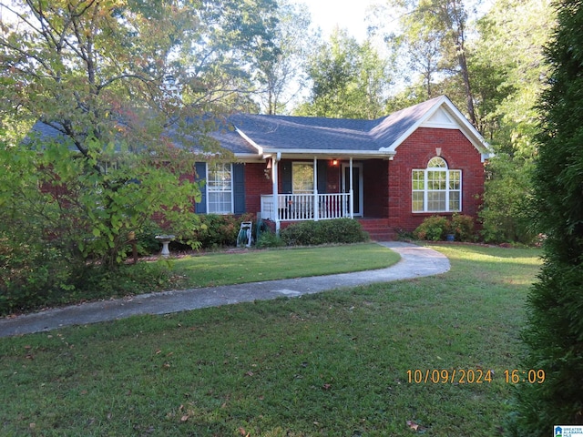 ranch-style house with a front yard and covered porch