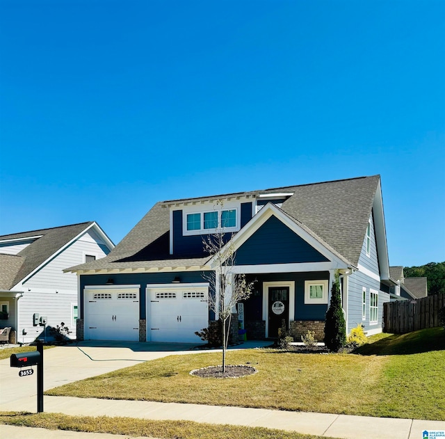 craftsman-style house featuring a front lawn and a garage