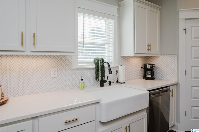 kitchen featuring white cabinets, dishwasher, backsplash, and sink