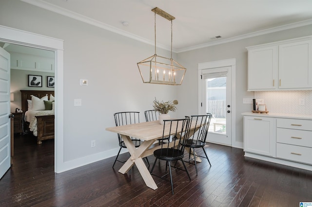 dining area with a chandelier, crown molding, and dark hardwood / wood-style flooring