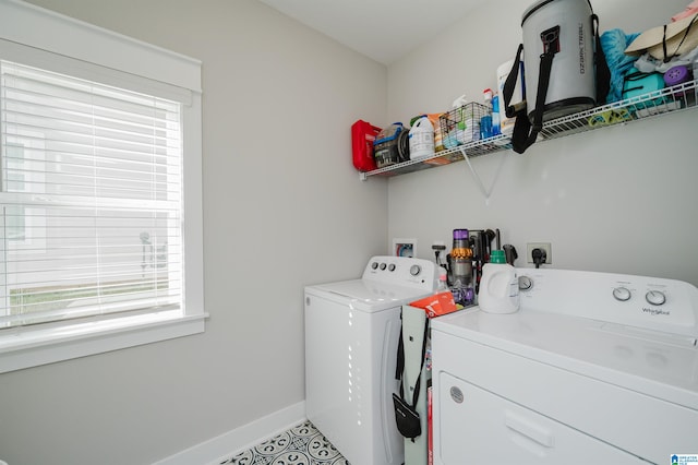 laundry area with light tile patterned flooring and washing machine and dryer