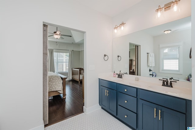 bathroom featuring ceiling fan, vanity, and wood-type flooring