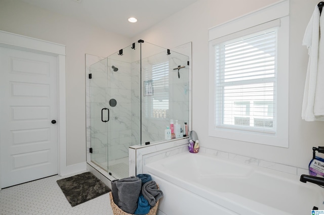 bathroom with tile patterned flooring and independent shower and bath