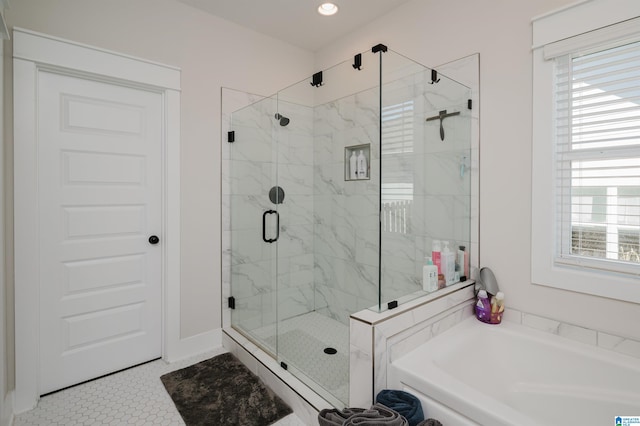 bathroom featuring tile patterned flooring and shower with separate bathtub