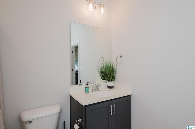 bathroom featuring vanity and toilet