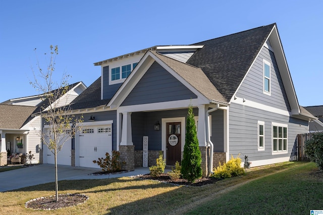 craftsman house featuring a front yard and a garage