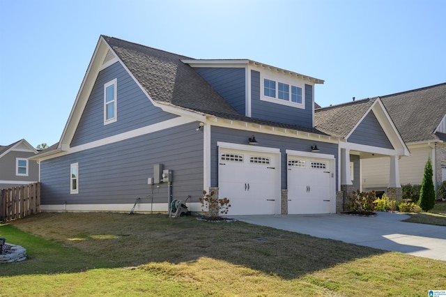 view of side of home featuring a yard and a garage