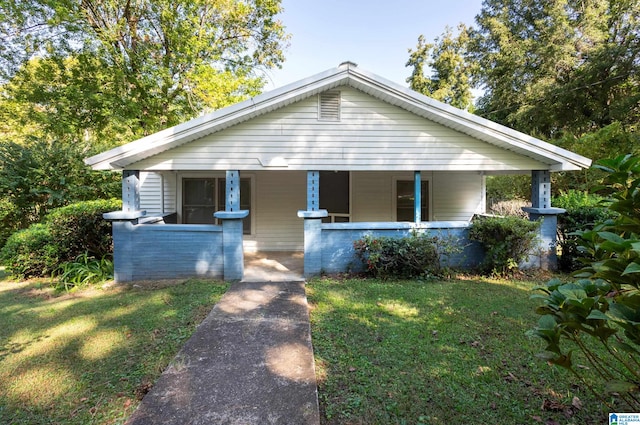 bungalow-style home with a porch and a front yard