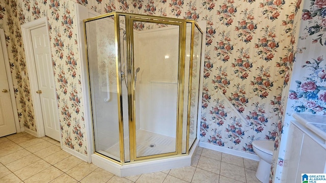 bathroom featuring a shower with door, tile patterned floors, and toilet