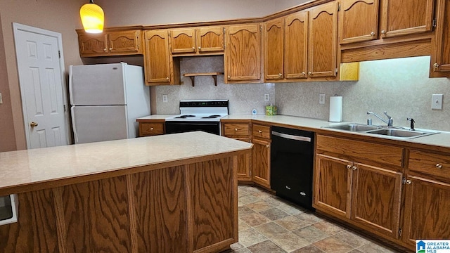 kitchen featuring pendant lighting, white appliances, tasteful backsplash, and sink