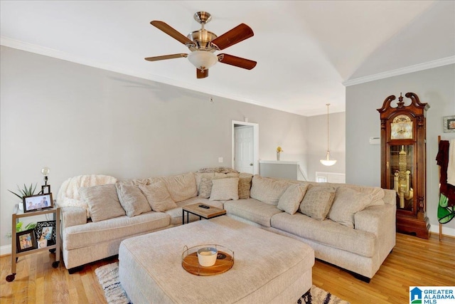 living room featuring crown molding, light hardwood / wood-style flooring, and ceiling fan