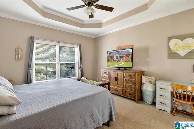 carpeted bedroom with a raised ceiling, ornamental molding, and ceiling fan