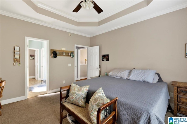 carpeted bedroom featuring ceiling fan, a raised ceiling, and crown molding