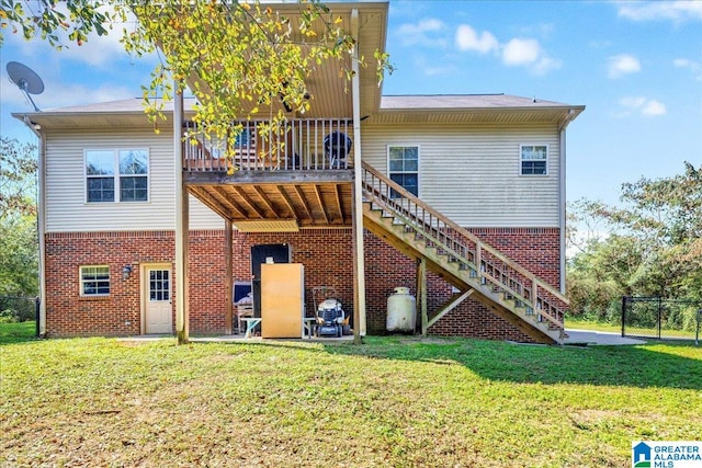 rear view of property featuring a deck and a yard