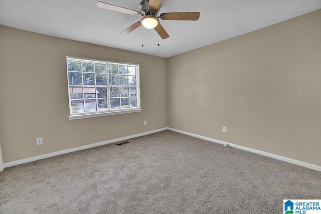 carpeted empty room featuring a textured ceiling and ceiling fan