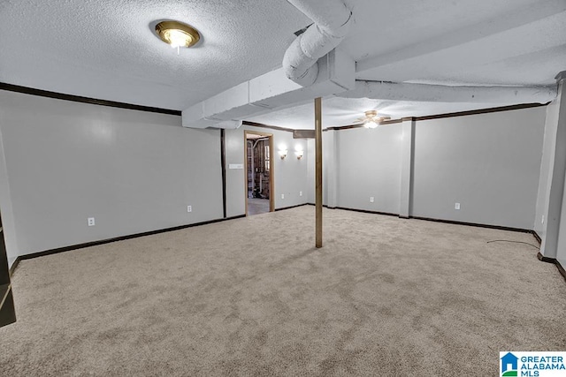 basement with a textured ceiling and carpet flooring