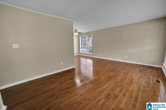 spare room with ceiling fan, wood-type flooring, and a textured ceiling