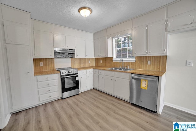 kitchen featuring white cabinets, appliances with stainless steel finishes, and sink