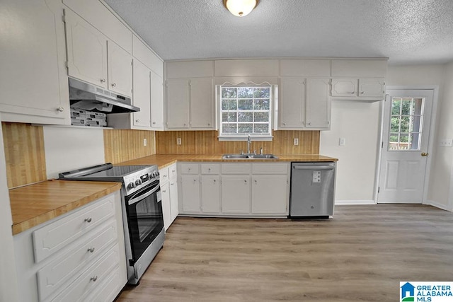 kitchen with light hardwood / wood-style flooring, sink, white cabinets, appliances with stainless steel finishes, and a textured ceiling