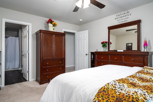 carpeted bedroom featuring ceiling fan and ensuite bathroom