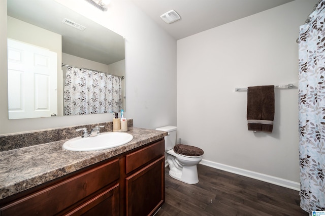 bathroom with hardwood / wood-style floors, vanity, and toilet