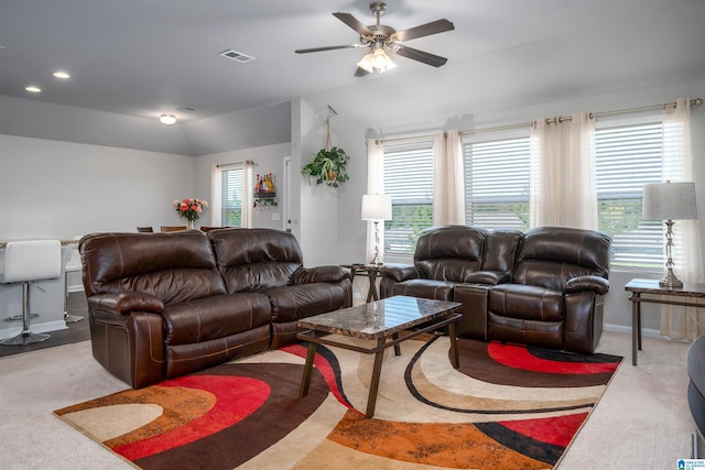 living room featuring ceiling fan, light colored carpet, and lofted ceiling