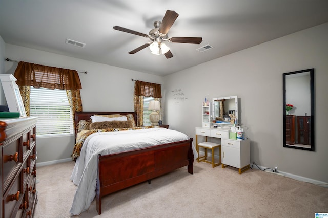 bedroom with ceiling fan and light carpet