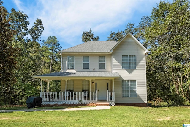 view of front of property with a front lawn and covered porch