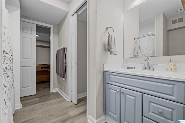 bathroom featuring vanity, hardwood / wood-style flooring, and curtained shower