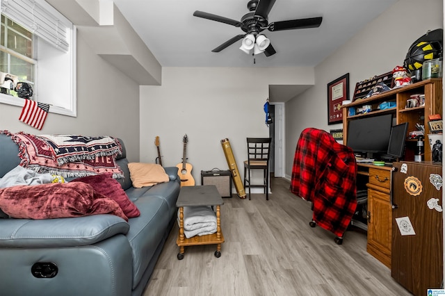 living room with ceiling fan and light hardwood / wood-style flooring