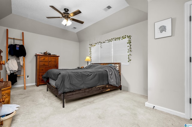 carpeted bedroom featuring ceiling fan, a textured ceiling, and vaulted ceiling