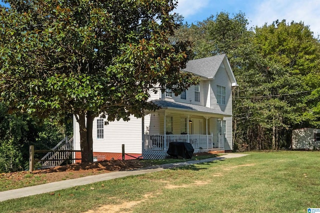 view of front of property with a front lawn and covered porch