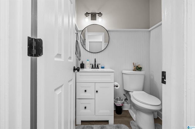 bathroom featuring vanity, hardwood / wood-style floors, and toilet