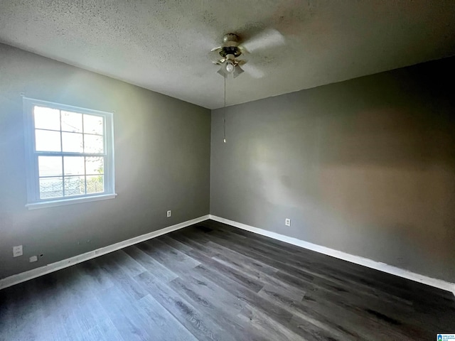 spare room featuring ceiling fan, a textured ceiling, and dark hardwood / wood-style flooring