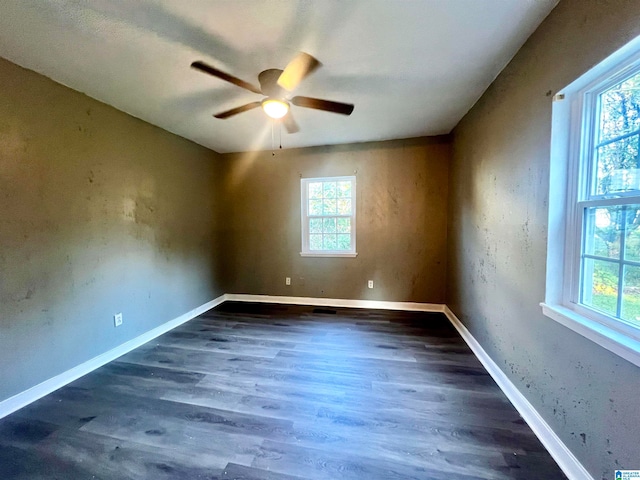 spare room with ceiling fan and dark wood-type flooring