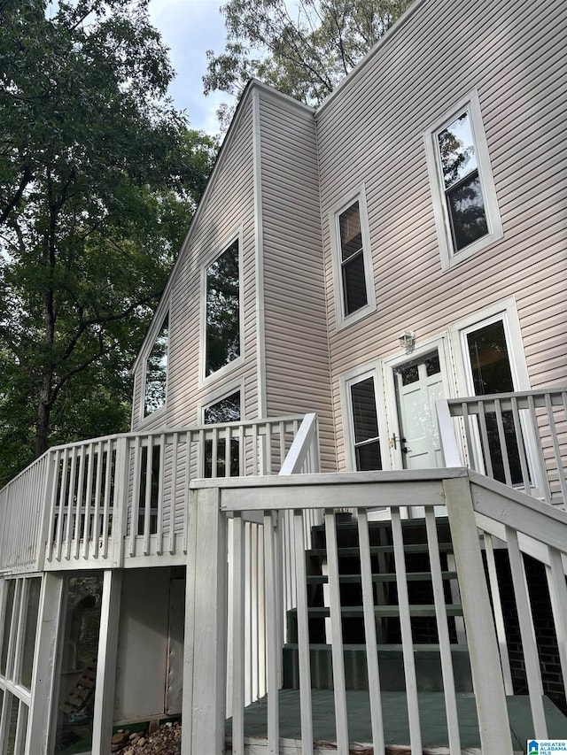 back of house featuring a wooden deck