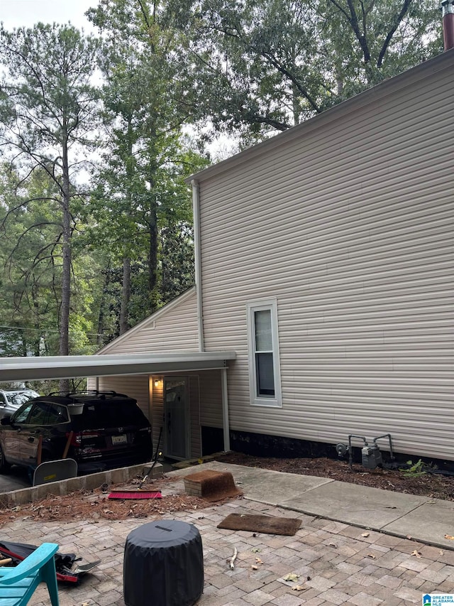 rear view of property featuring a carport