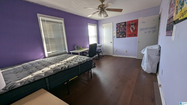 bedroom featuring ceiling fan, a textured ceiling, and dark hardwood / wood-style floors