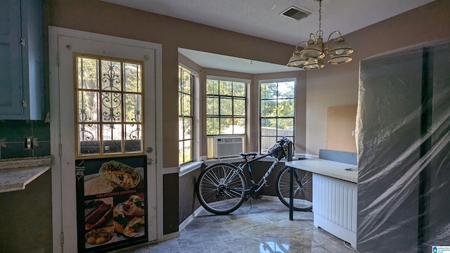 interior space featuring cooling unit and an inviting chandelier