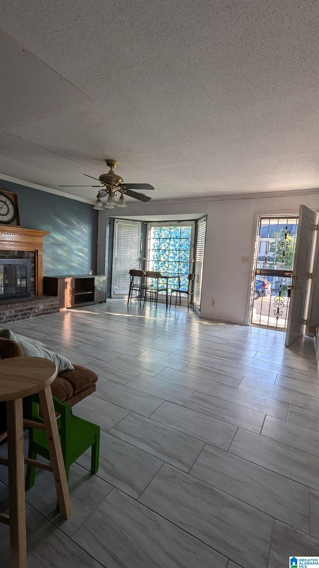 unfurnished living room with ceiling fan and a textured ceiling