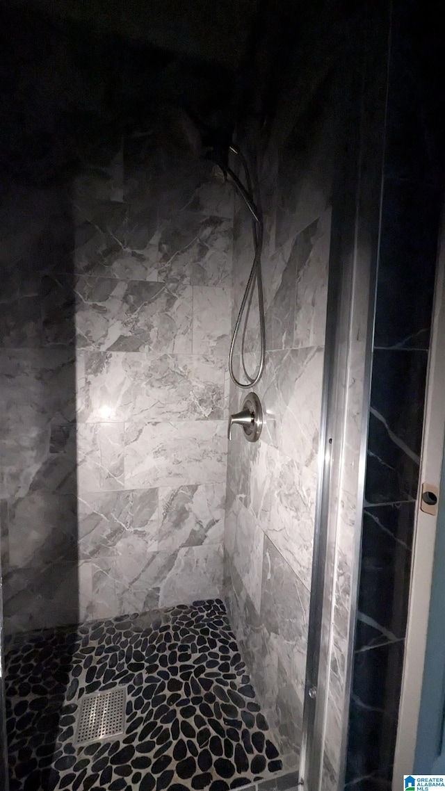 bathroom with a tile shower