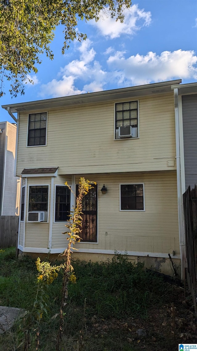 rear view of property featuring cooling unit