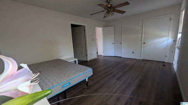 bedroom featuring ceiling fan and dark hardwood / wood-style flooring