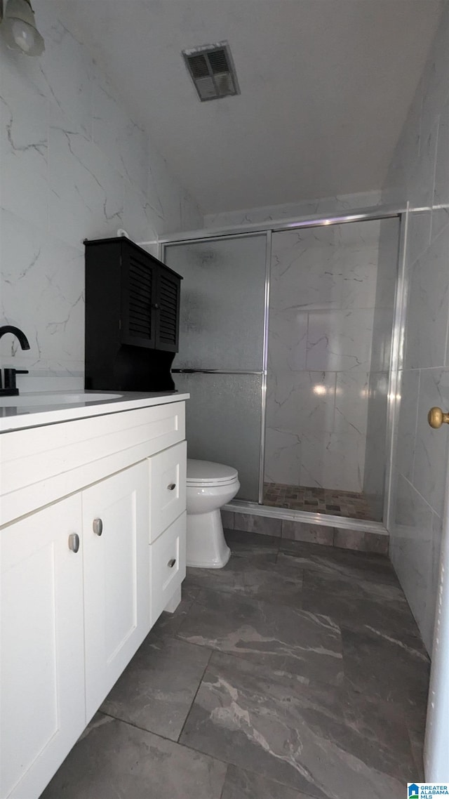 bathroom featuring an enclosed shower, toilet, and vanity