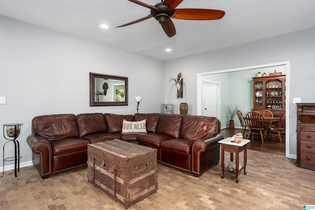 living room with light hardwood / wood-style flooring and ceiling fan