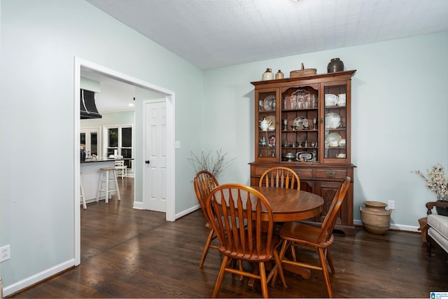 dining room with dark hardwood / wood-style flooring