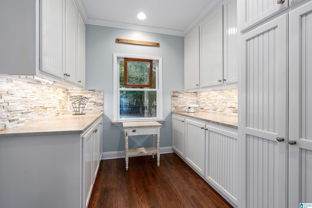 kitchen featuring white cabinets, ornamental molding, and backsplash