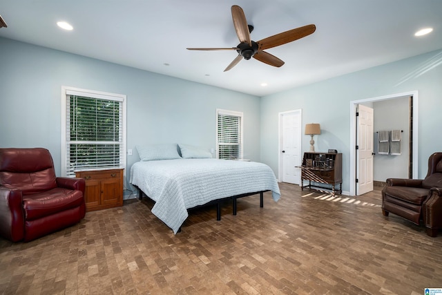 bedroom with dark hardwood / wood-style flooring and ceiling fan