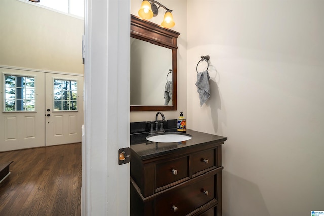 bathroom featuring wood-type flooring, vanity, and french doors