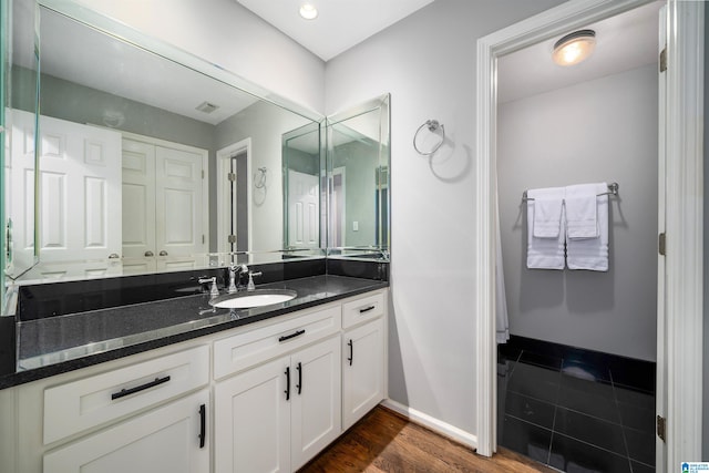 bathroom with vanity and hardwood / wood-style floors